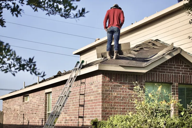 Professional roofer working on a residential roof in Bridge Valley